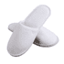 White hotel slippers with a soft texture and simple design, featuring a subtle branding logo.