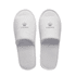 White open toe hotel slippers featuring a logo on the upper. Soft, plush material with a textured sole.