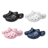 A set of four pairs of clog slides in black, white, pink, and navy blue, featuring ventilation holes and a logo.