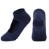 A pair of navy yoga socks with an open top and textured grip on the soles. The socks feature a logo.