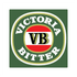 A green square coaster featuring a circular logo with red, white, and black elements, and a gold border.