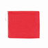 A red poncho is folded and packaged in a compact design, featuring a drawstring closure and a subtle logo.
