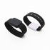 Two silicone bracelets, one black and one white, featuring a USB flash drive, with a logo on the white bracelet.