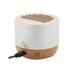 A cylindrical speaker featuring a bamboo top and a cork bottom, with a charging port visible. It has a recycling logo.