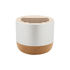 A round wireless speaker with a white top and a natural cork base, featuring slits on the top for sound.