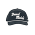 A dark grey cap featuring white embroidered text and a braid along the brim, with a logo present.