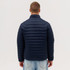 A puffer jacket in navy blue, featuring a quilted design, viewed from the back on a model.