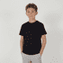 A youth essential tee in black, featuring a classic crew neck design. The model is standing with hands in pockets.
