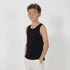A black youth singlet with a relaxed fit, featuring a logo. The model is standing with hands in pockets.