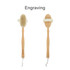 A detachable shower brush with a long wooden handle and natural bristles, featuring a strap for grip.