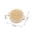 An exfoliating brush with soft massage nodules, featuring a round design in natural tones, measuring 11 cm in diameter.