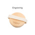 A round exfoliating brush with soft massage nodules, featuring a wooden top and a fabric strap. Includes branding.