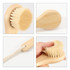 A natural wooden face brush in light wood with soft bristles, featuring a rope handle.