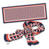 A vibrant Berlin Scarf featuring a geometric pattern in navy, red, and white, with a branding label.