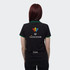 A black women's polo shirt with green accents, featuring a logo on the back and a name on the lower hem.