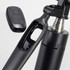 A black selfie stick tripod with a remote control attached, featuring a shiny metallic section and a sleek design.