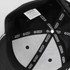 A black cap featuring an inner lining with branding and ventilation holes.