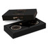 A black packaging box featuring a dual wireless charger with gold accents and a logo.