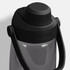 A drink bottle in clear plastic with a black lid and handle, featuring a logo on the top.