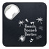 A drink bottle opener and coaster in black with a silver opener, featuring tropical-themed graphics.