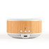 A round speaker and wireless charger in natural wood and white, featuring control buttons and a USB-C port.