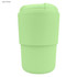 A light green reusable coffee cup with a ribbed silicone sleeve and a secure lid, featuring a logo.