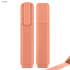 An orange highlighter with a clip, featuring a smooth, rounded design and a subtle glitter finish.