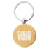 A wooden round key ring with a silver metal attachment, featuring a logo on one side.