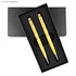 A black rectangular box containing two gold pens, nestled in black foam padding, with a logo on the box.