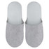 Felt slippers in light grey with a simple design and soft texture, featuring a logo on one slipper.