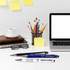 A collection of three metal pens in blue, black, and white, beside a laptop, notebook, glasses, and a coffee cup.