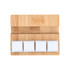 A bamboo stand featuring three white square stress reliever blocks on a smooth surface.