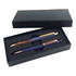 A gift set featuring two metal pens in a black box, one with a wooden finish and gold accents, and one in navy blue with rose gold accents.