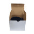 A ceramic mug in black inside a plain cardboard box, featuring a handle and a simple design.