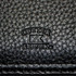 A close-up of a black Nappa leather zippered compendium featuring the Cutter & Buck logo.