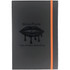 A dark grey journal with an orange elastic band and an embossed logo on the cover.