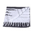 A Turkish beach towel with a dark grey and white striped design, featuring fringed edges and a small logo.
