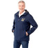 A man in a navy rain jacket with a hood and a logo, smiling and standing with hands in pockets.