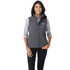 A woman wearing a grey softshell vest, featuring a logo, with a button-up shirt underneath.