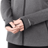 A close-up of a women's grey eco knit jacket with a fitted design and long sleeves. It features a logo.