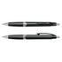 A pair of green plastic pens with black grips and silver accents, featuring a logo on the barrel.