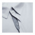 A light grey men's polo shirt with a collar and buttons, featuring a textured fabric and a logo.