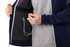 A navy performance jacket with a grey inner lining, featuring thumb holes and an earphone port inside.