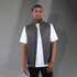 A lightweight packable insulated puffer vest in dark grey, featuring a high collar and a fitted design.