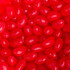 Red jelly beans scattered closely together with a glossy finish, featuring a variety of shapes and sizes.