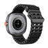 A sleek black smart watch featuring a silver casing and an orange button, with a black perforated strap.