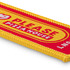 A woven keytag in red and yellow with a branded logo and text design.