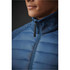A close-up of a men's hybrid jacket featuring a blue quilted design and a high collar. The jacket has a zipper and a logo.