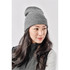 A grey knit beanie worn by a woman with long, dark hair, featuring a simple design and a logo.