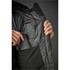 A woman's Oslo HD Parka in dark green, featuring a zipped inner pocket and a logo. 